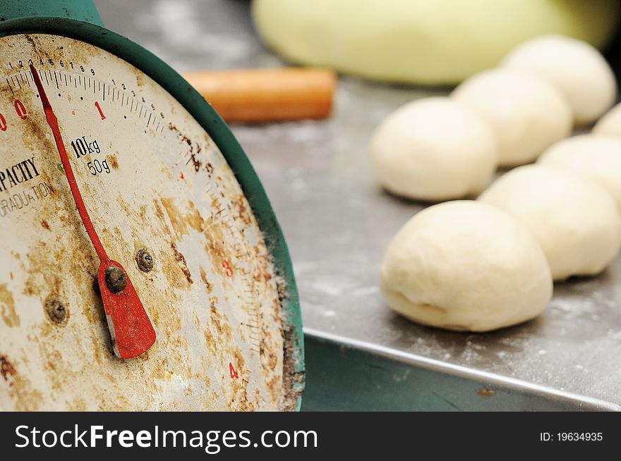 Close up old bakering weight scale machine isolated dough and bakering roller in blur at background