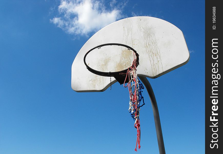 Close up shot of a basketball net that is dirty and used with cloud in back round. Close up shot of a basketball net that is dirty and used with cloud in back round.