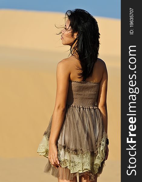 Young Asian woman in the dunes