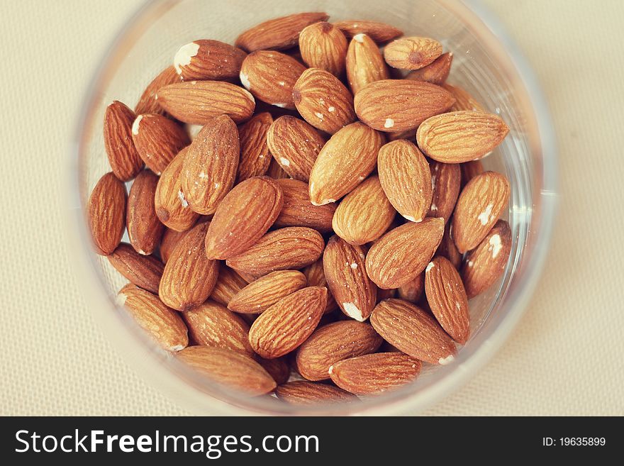 Tasty and useful almonds in a glass jar