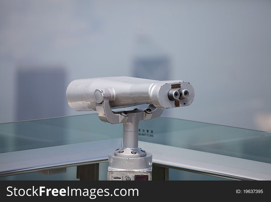 Telescope at a lookout point in front of blue sky