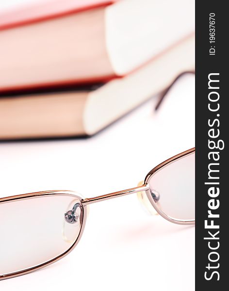 Glasses close up and the books on a background. Glasses close up and the books on a background