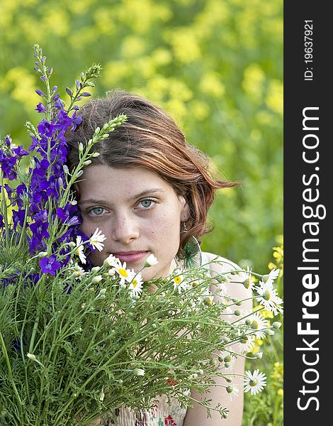 Portrait of a girl in a flower field. Portrait of a girl in a flower field