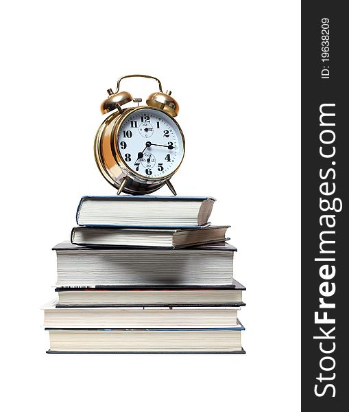 Alarm clock standing on stack of books. Isolated on white with clipping path. Alarm clock standing on stack of books. Isolated on white with clipping path
