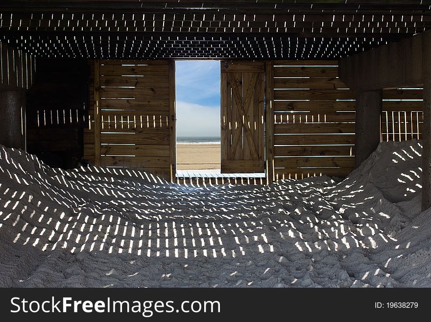 A unique view, with light, shadows and textures as seen from under a seaside boardwalk. A unique view, with light, shadows and textures as seen from under a seaside boardwalk