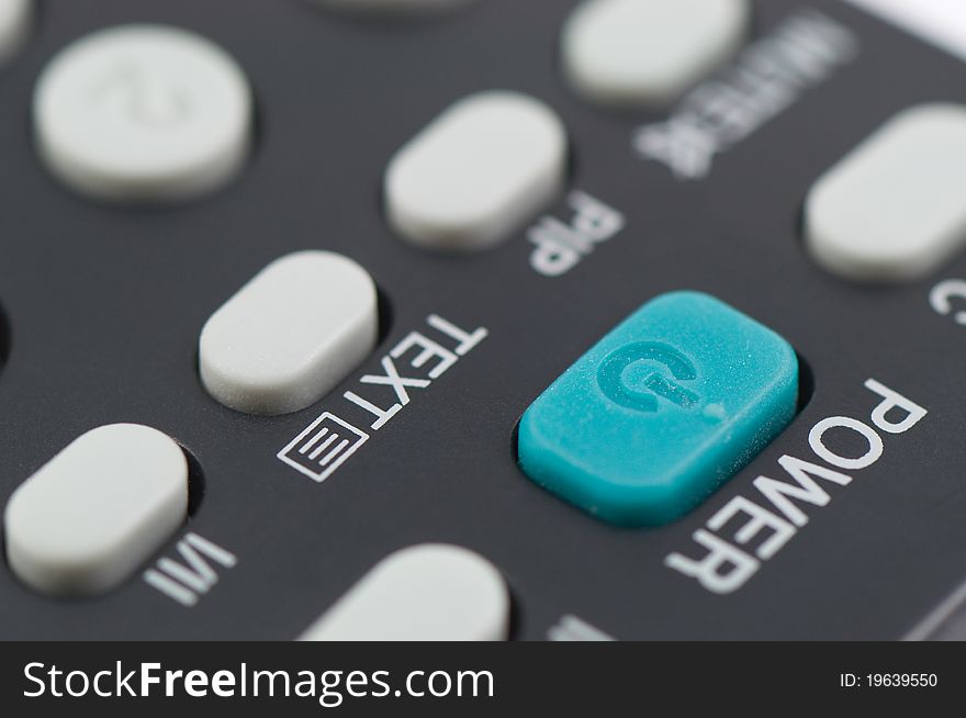 Blue power button sign on remote control TV close up