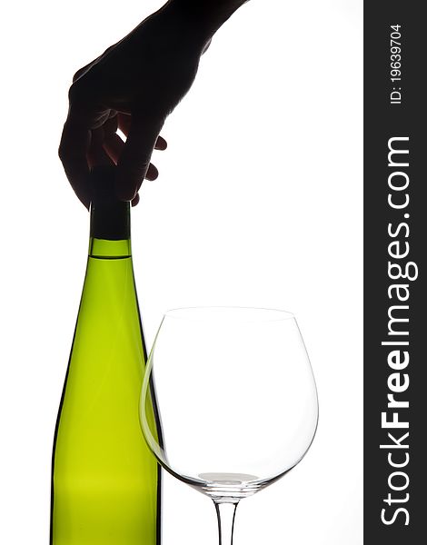 Glass and bottle of white wine with a hand. Glass and bottle of white wine with a hand