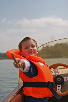 Boy In Life Jacket Pointing Out Royalty Free Stock Photography Boy In Life Jacket Pointing Out Royalty Free Stock Photography