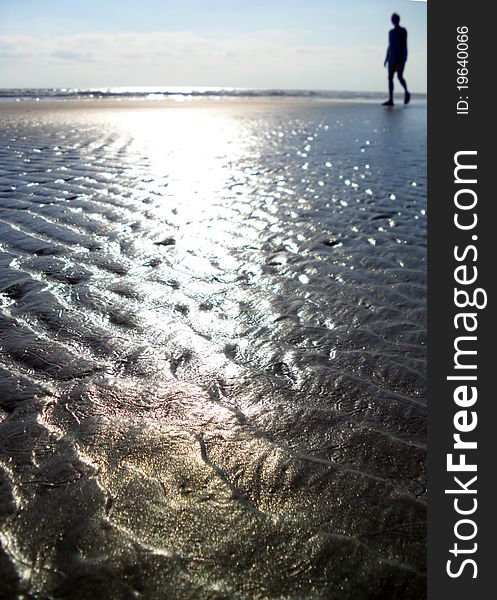 Silhouette of a man walking on the beach. Silhouette of a man walking on the beach