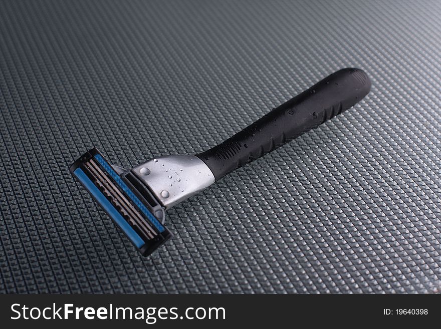 Disposable shaving razor on a glass background