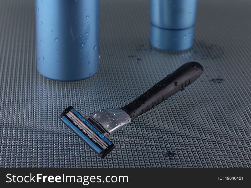 Foam for shaving, a cream after shaving on dark blue background. Foam for shaving, a cream after shaving on dark blue background