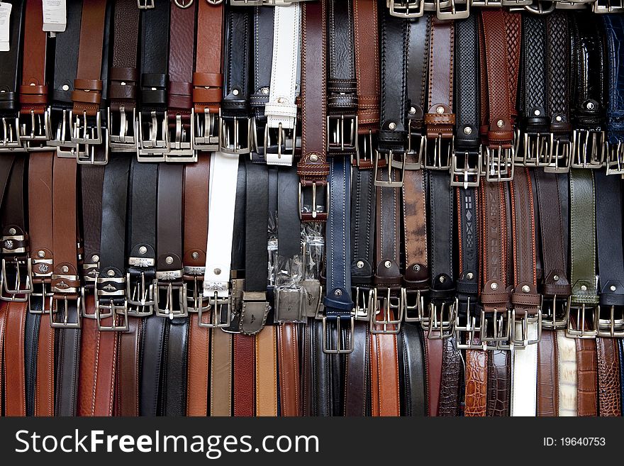 Display of leather belts at an Italian market