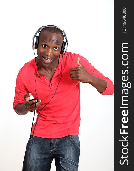 Man with red shirt listening to music with headphones. Man with red shirt listening to music with headphones