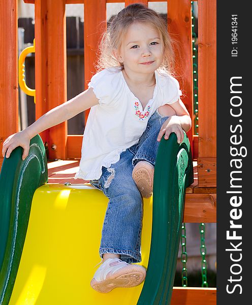 A photograph of an adorable child playing on some playground equipment. A photograph of an adorable child playing on some playground equipment.