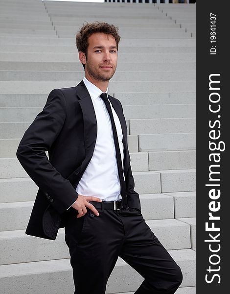 Young business man standing at stairs