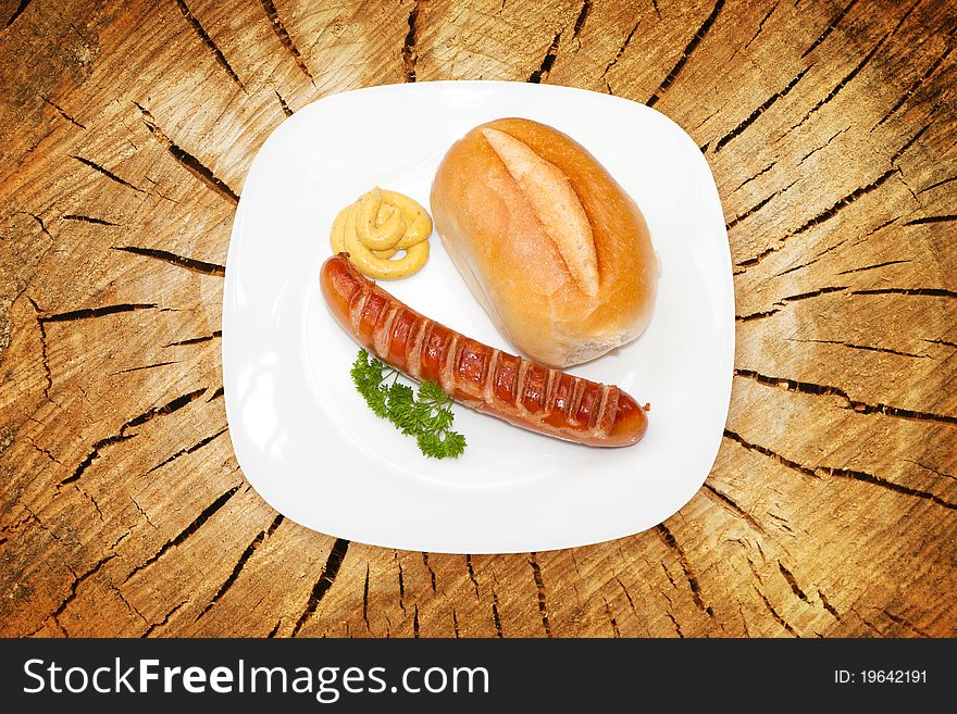 Grilled Sausage - Bratwurst with mustard, bread and parsley. Grilled Sausage - Bratwurst with mustard, bread and parsley