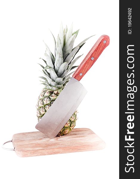 Pineapple in table with blade on white background