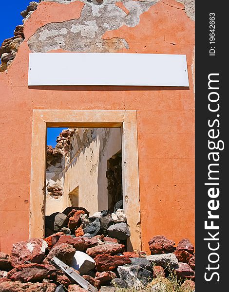 Part of architecture in abandoned house with blank billboard in beautiful village of Oia in Santorini, Greece. Part of architecture in abandoned house with blank billboard in beautiful village of Oia in Santorini, Greece