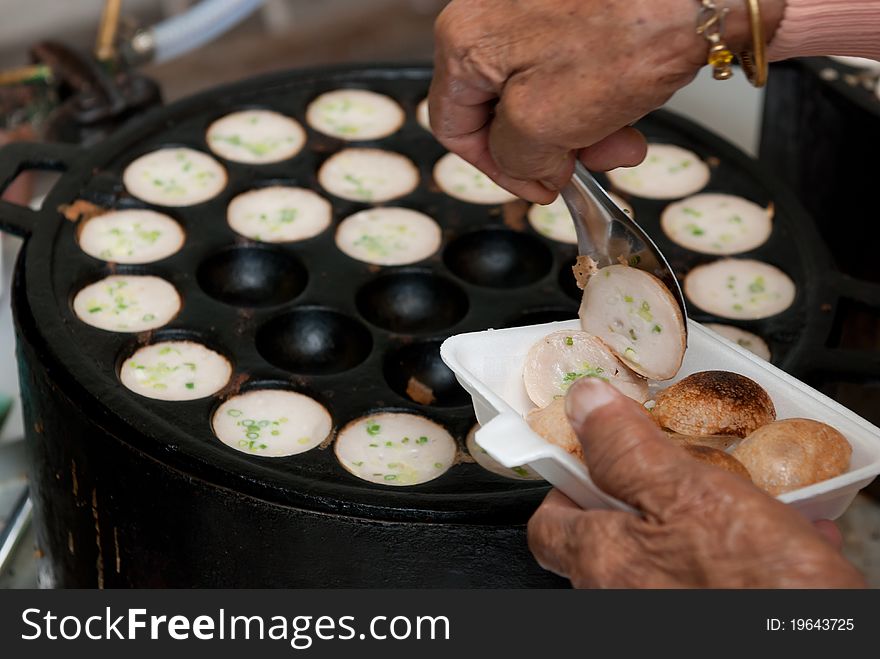 Kind of Thai sweetmeat . Coconut milk mix with powder fried dessert.