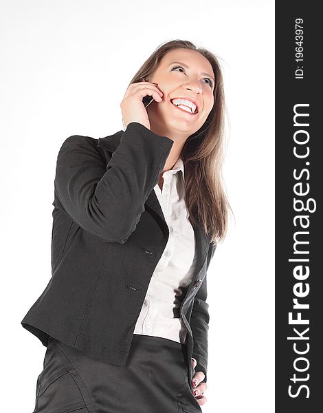 The business woman speaks on the phone and is happy. The business woman speaks on the phone and is happy