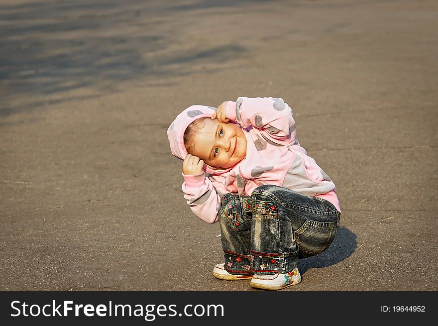 Child playing on the asphalt