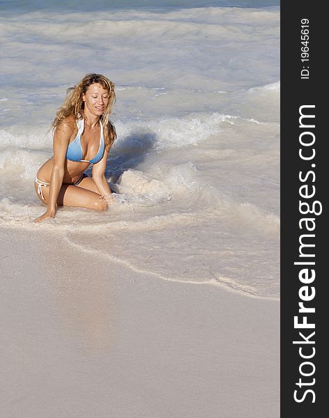 Beatiful Woman In Bikini Sitting On The Beach