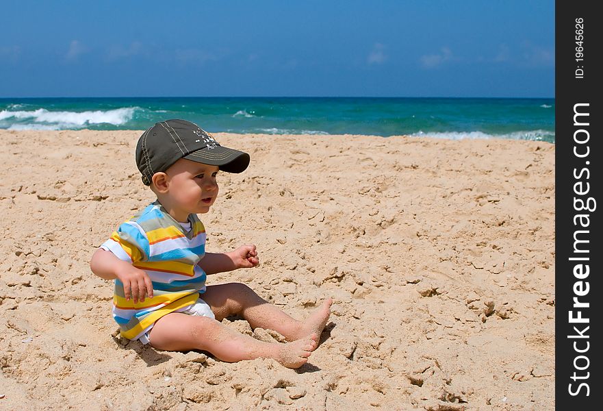 One year old boy sitting on sand. One year old boy sitting on sand