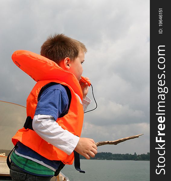 Boy in life vest blowing a whistle