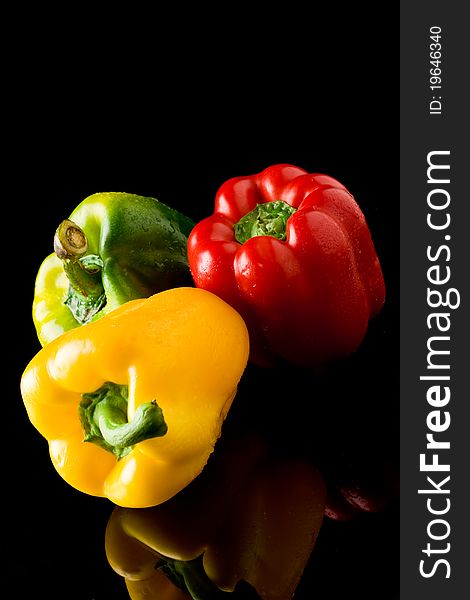 Photo of fresh vivid colorful pepper on black background. Photo of fresh vivid colorful pepper on black background