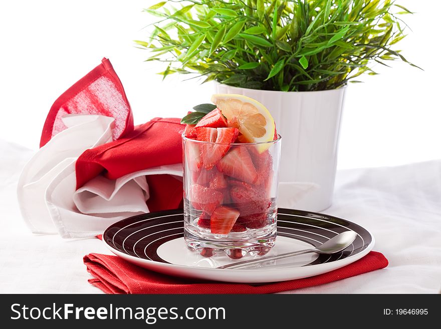 Photo of strawberry salad with sliced lemon on white background. Photo of strawberry salad with sliced lemon on white background