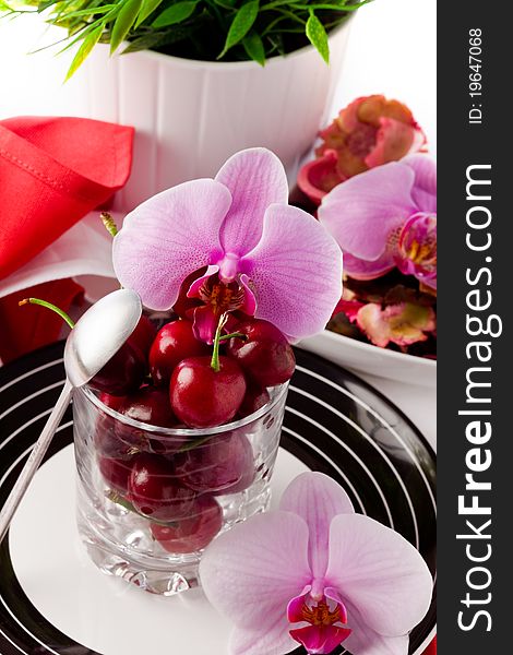 Photo of Cherry cocktail with orchid on white background. Photo of Cherry cocktail with orchid on white background