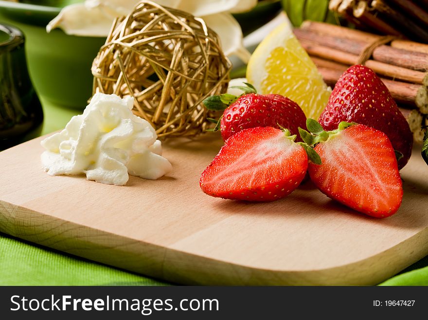 Photo of delicious cutted strawberries with whipped cream. Photo of delicious cutted strawberries with whipped cream