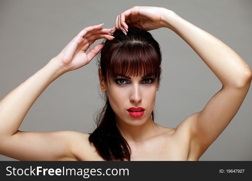 Attractive brunette making her hair. Attractive brunette making her hair