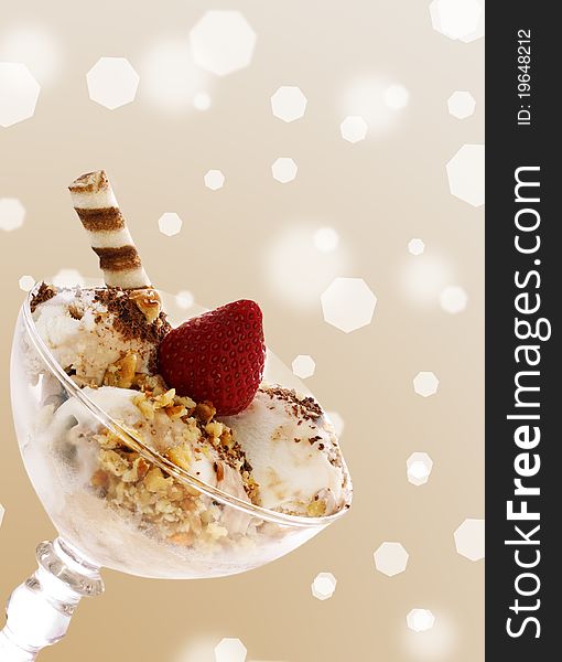 Ice cream with strawberry and nuts in a  glass bowl over brown. Ice cream with strawberry and nuts in a  glass bowl over brown
