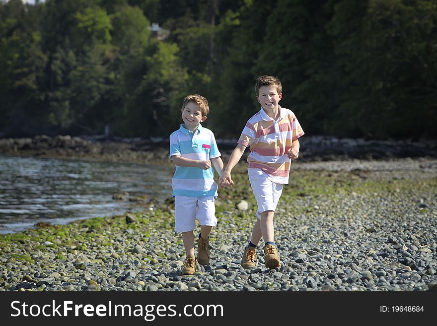 Two boys walking on a beach. Two boys walking on a beach