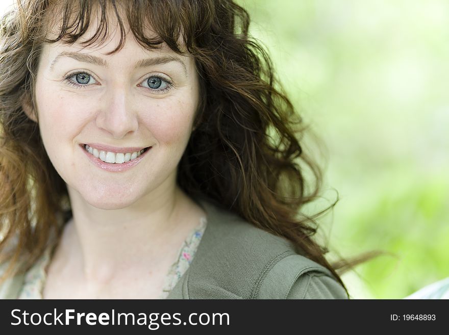 Portrait of a Pretty Young Woman Smiling Directly to the Camera. Portrait of a Pretty Young Woman Smiling Directly to the Camera