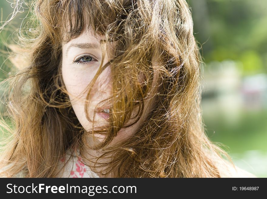 Portrait of a Pretty Young Woman with Windblown Hair across Her Face. Portrait of a Pretty Young Woman with Windblown Hair across Her Face