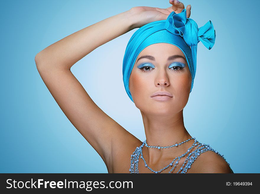 Young woman in blue scarf on the head with health skin of face