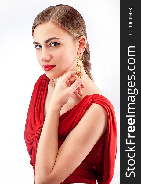 Portrait of young beautiful woman with red lips in red dress