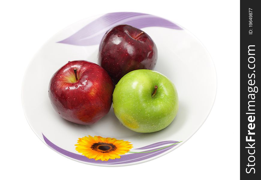 Three green apples in plate isolated on white background. Three green apples in plate isolated on white background.