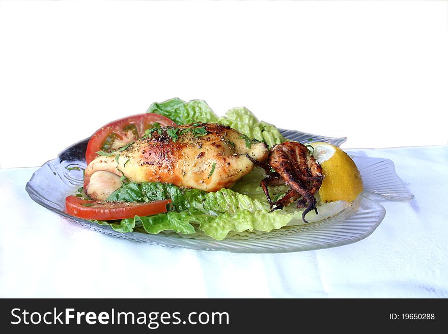 Calamari with salad on a glass plate