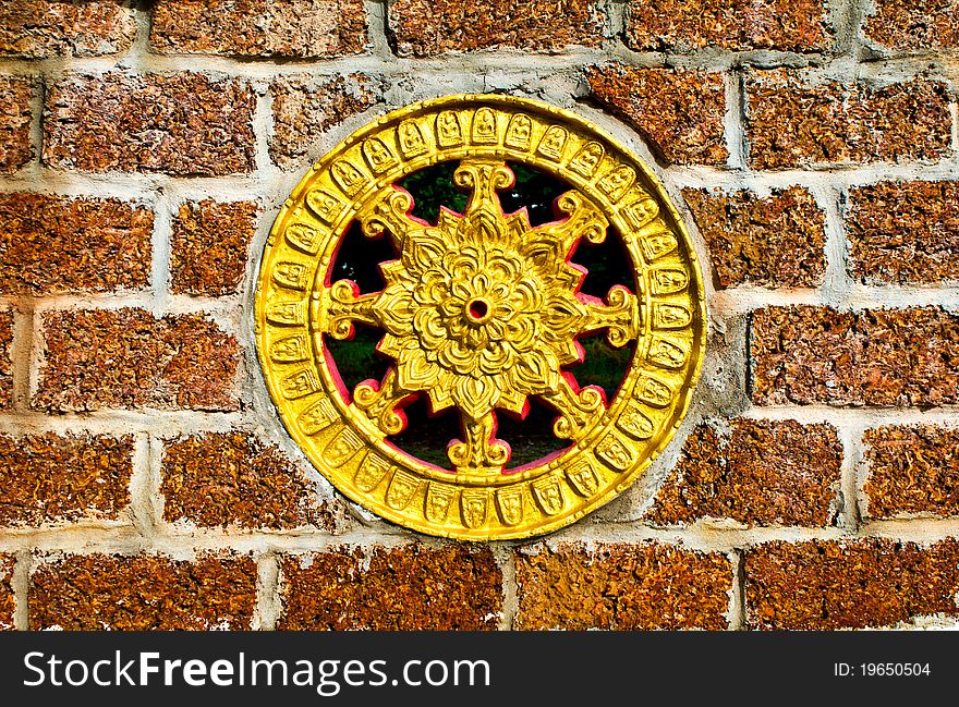 Thammachak wheel. Embedded in a brick wall.