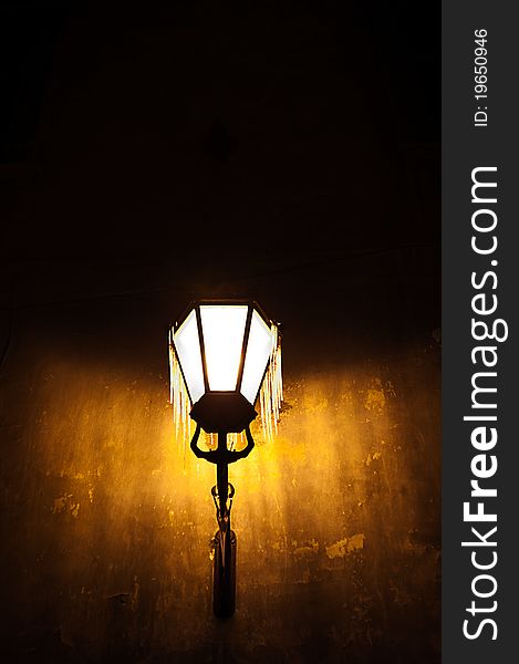 Illuminated street lamps, which is hanged by the icicles, the ancient Lviv