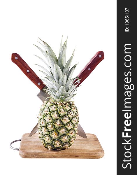 Pineapple in table with knifes on white background