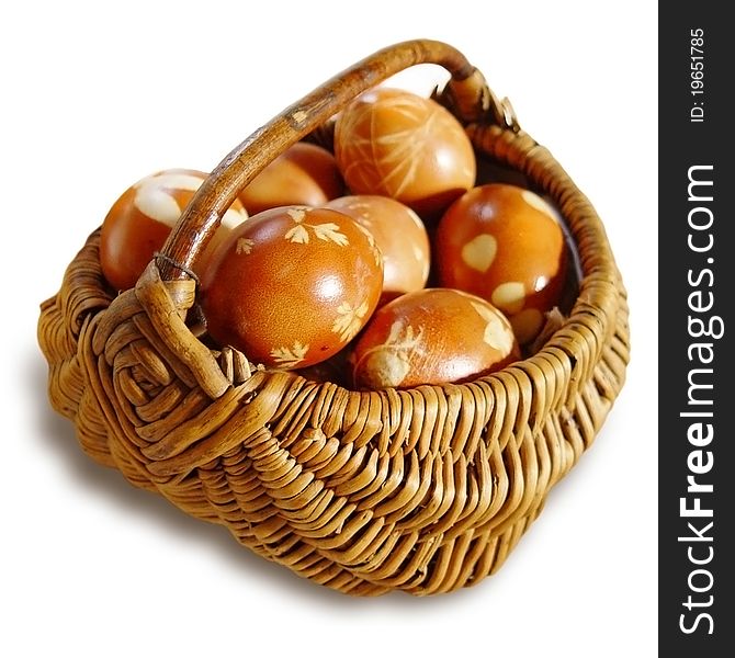 Ritual eggs in wicker basket on white background