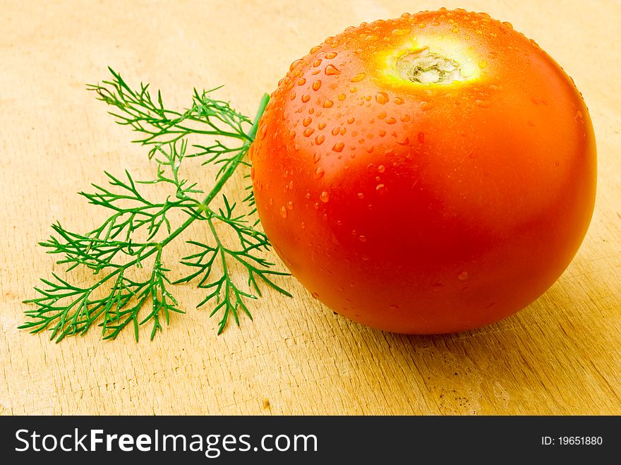 A red tomato on the wooden table