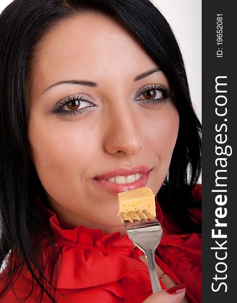 Attractive pretty brunette in red, with a delicious slice of cheese on a fork