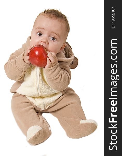 Baby holding and eating an apple