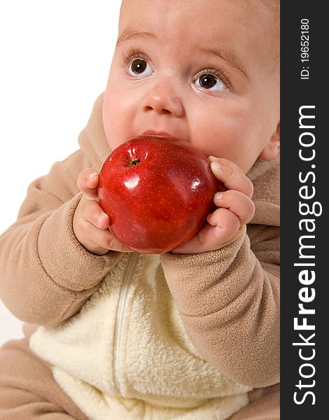 Baby holding and eating an apple
