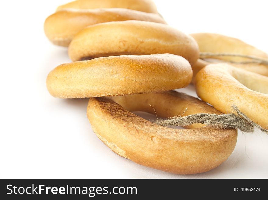 Many bagels tied with rope. Isolated on white background